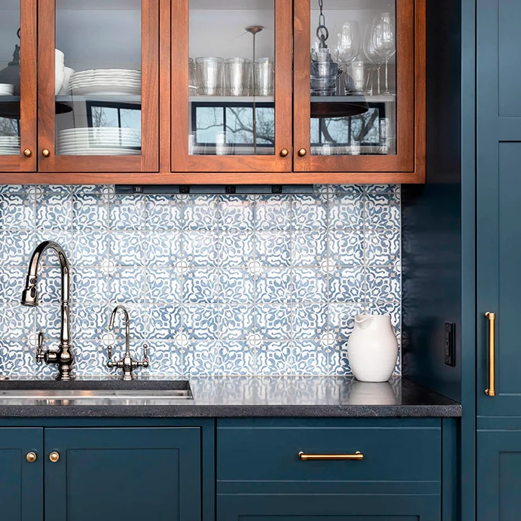 Wood and blue cabinetry with glass doors and patterned backsplash